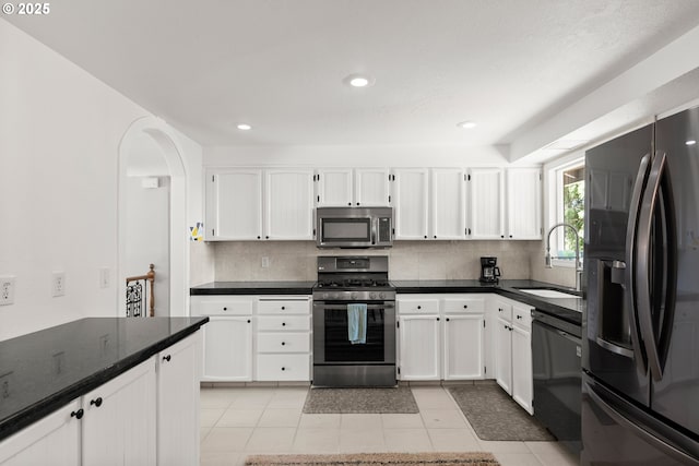 kitchen with black appliances, a sink, tasteful backsplash, white cabinets, and recessed lighting