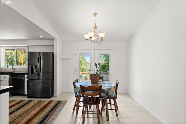dining room with a chandelier, plenty of natural light, light tile patterned floors, baseboards, and recessed lighting