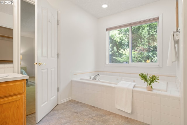 ensuite bathroom with a garden tub and vanity