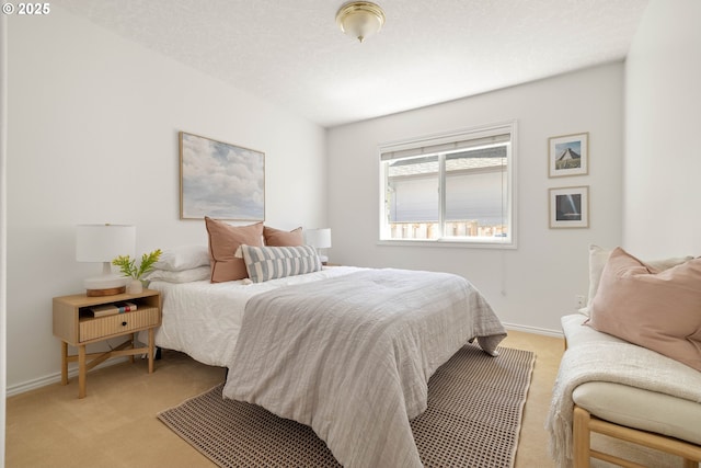bedroom with light carpet and baseboards
