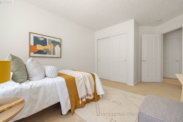 bedroom featuring carpet floors, a closet, and a textured ceiling