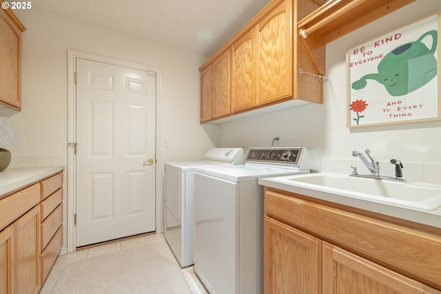 laundry room featuring cabinet space, independent washer and dryer, and light tile patterned flooring