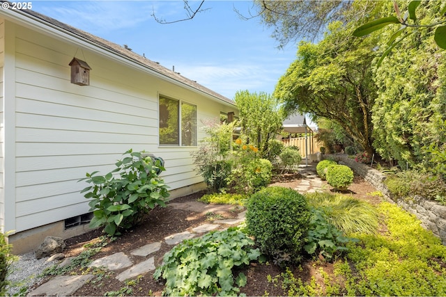 view of side of home with fence