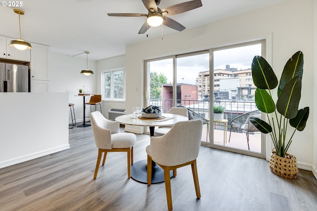 2021 SW Main St Unit 66, Portland, OR 97205 - dining space featuring light wood-style flooring, ceiling fan, and baseboards