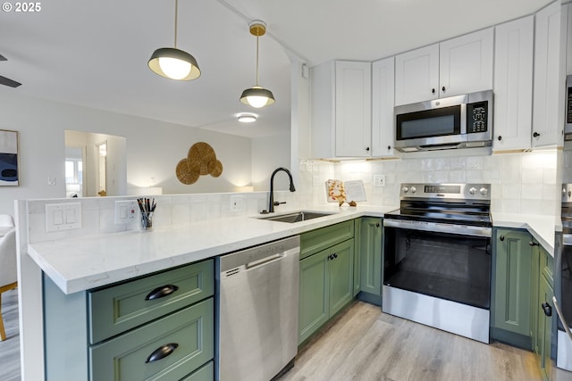 2021 SW Main St Unit 66, Portland, OR 97205 - kitchen with green cabinets, appliances with stainless steel finishes, and a sink