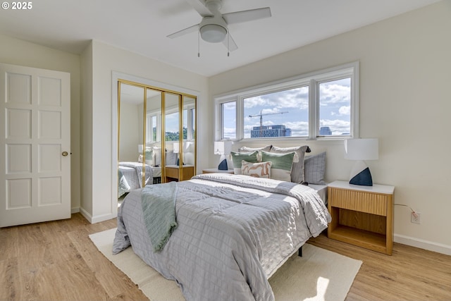 2021 SW Main St Unit 66, Portland, OR 97205 - bedroom featuring light wood-style floors, baseboards, a closet, and a ceiling fan