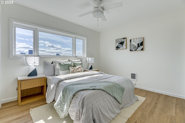 2021 SW Main St Unit 66, Portland, OR 97205 - bedroom featuring light wood-type flooring, baseboards, and ceiling fan
