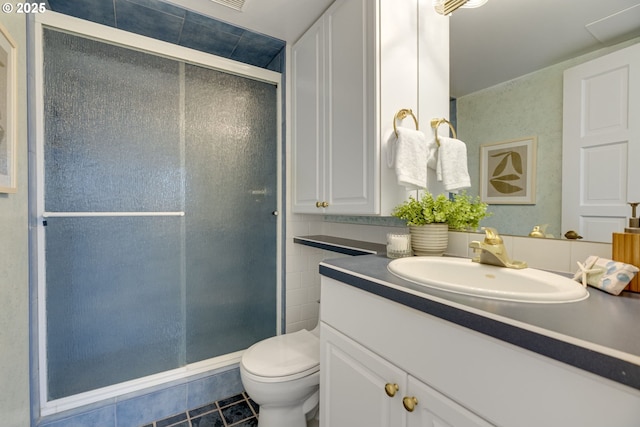 2021 SW Main St Unit 66, Portland, OR 97205 - full bath featuring vanity, a stall shower, toilet, and tile patterned flooring