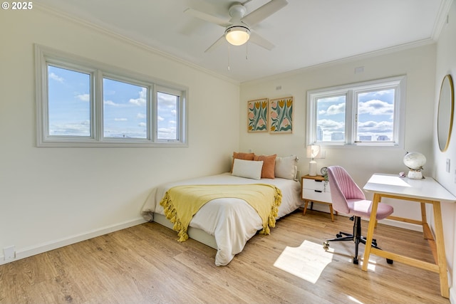 2021 SW Main St Unit 66, Portland, OR 97205 - bedroom featuring light wood finished floors, crown molding, multiple windows, and baseboards