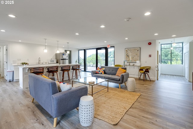 2021 SW Main St Unit 66, Portland, OR 97205 - living area featuring light wood finished floors, recessed lighting, and baseboards