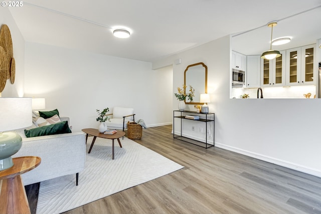 2021 SW Main St Unit 66, Portland, OR 97205 - living room featuring wood finished floors and baseboards
