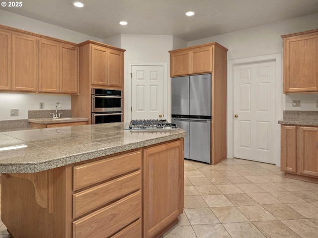 3165 SW Garden View Ave, Portland, OR 97225 - kitchen featuring appliances with stainless steel finishes, a sink, tile counters, recessed lighting, and a center island