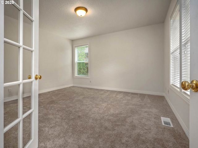3165 SW Garden View Ave, Portland, OR 97225 - empty room with carpet floors, a textured ceiling, and baseboards