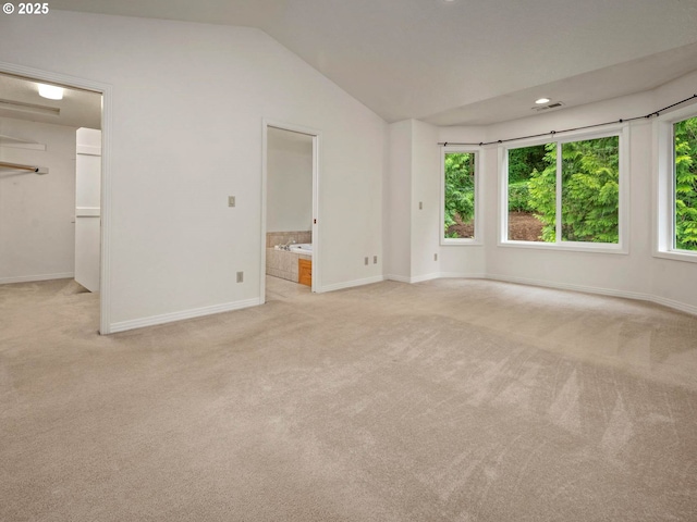 3165 SW Garden View Ave, Portland, OR 97225 - unfurnished bedroom with carpet, baseboards, vaulted ceiling, connected bathroom, and a spacious closet
