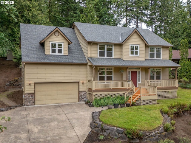 3165 SW Garden View Ave, Portland, OR 97225 - view of front facade featuring concrete driveway, roof with shingles, covered porch, stone siding, and an attached garage