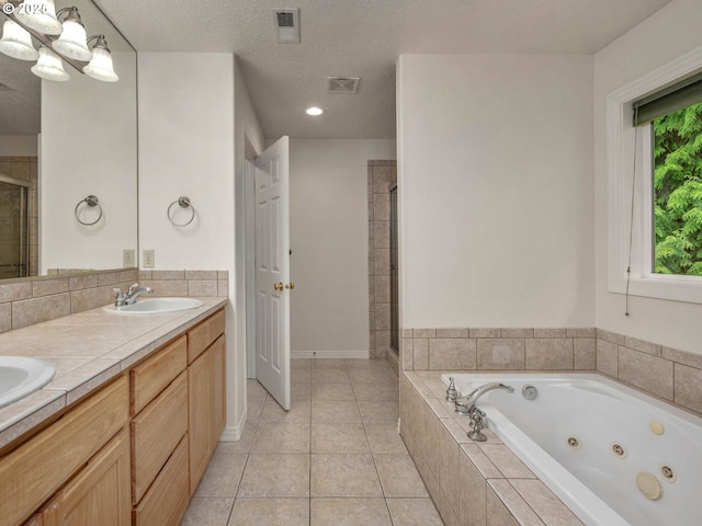 3165 SW Garden View Ave, Portland, OR 97225 - bathroom with a shower stall, a jetted tub, double vanity, tile patterned flooring, and a textured ceiling