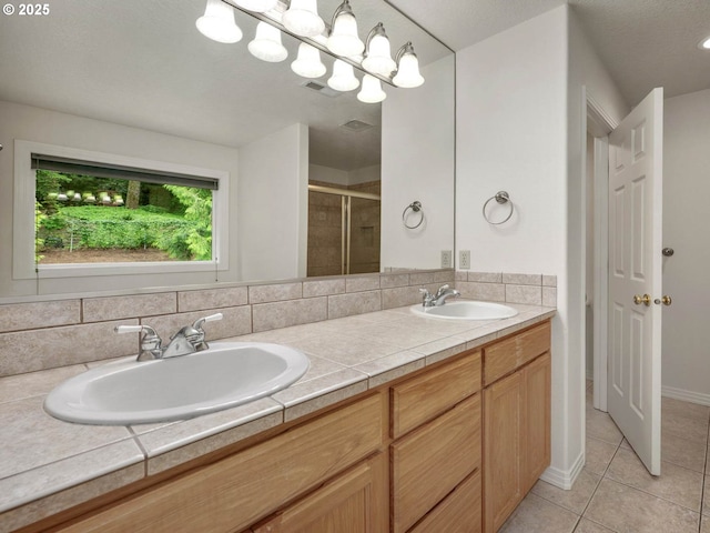 3165 SW Garden View Ave, Portland, OR 97225 - bathroom with double vanity, a shower stall, and tile patterned floors