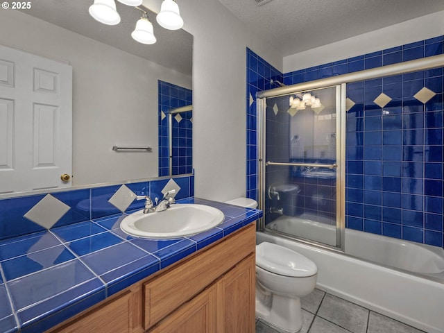 3165 SW Garden View Ave, Portland, OR 97225 - bathroom with toilet, vanity, tile patterned flooring, enclosed tub / shower combo, and a textured ceiling