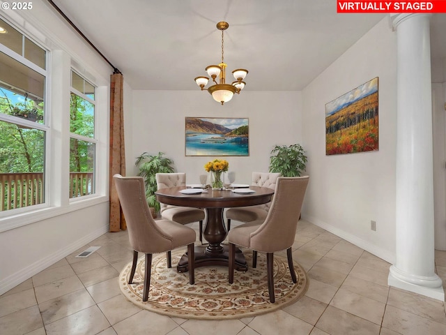 3165 SW Garden View Ave, Portland, OR 97225 - dining area with a chandelier, baseboards, light tile patterned floors, and ornate columns
