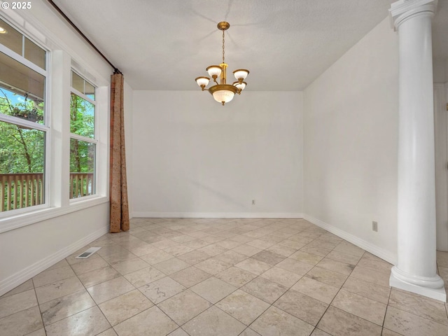 3165 SW Garden View Ave, Portland, OR 97225 - empty room featuring ornate columns, healthy amount of natural light, a chandelier, and baseboards