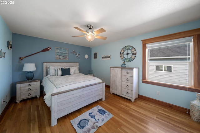 93885 Boulder Pl, Gold Beach, OR 97444 - bedroom featuring baseboards, a ceiling fan, and wood finished floors