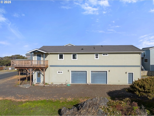 93885 Boulder Pl, Gold Beach, OR 97444 - rear view of property featuring an attached garage and a wooden deck