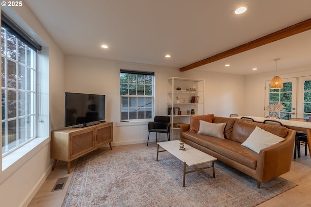 living area with recessed lighting, beamed ceiling, light wood-style flooring, and baseboards