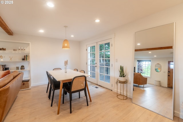 dining room featuring plenty of natural light, recessed lighting, light wood finished floors, beam ceiling, and baseboards