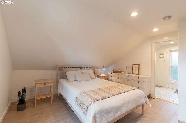 bedroom with light wood-type flooring, lofted ceiling, baseboards, and recessed lighting