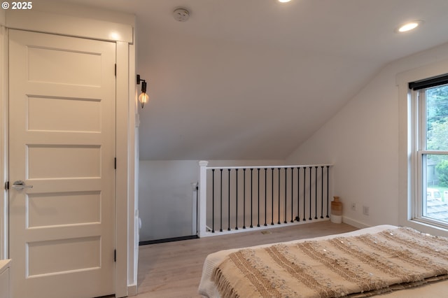 bedroom featuring lofted ceiling, recessed lighting, baseboards, and light wood-style floors