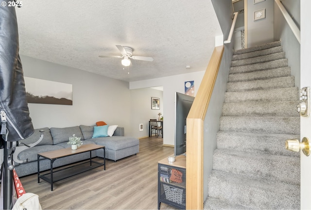 4000 NE 109th Ave Unit 169, Vancouver, WA 98682 - living room featuring a ceiling fan, wood finished floors, stairway, and a textured ceiling