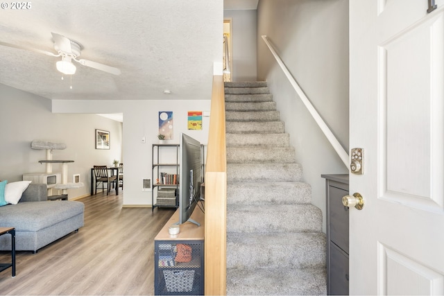 4000 NE 109th Ave Unit 169, Vancouver, WA 98682 - staircase featuring wood finished floors, ceiling fan, a textured ceiling, and baseboards