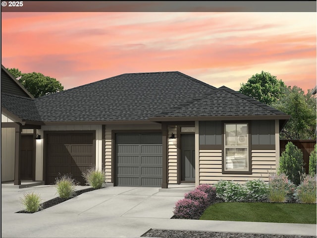 view of front facade with an attached garage, board and batten siding, concrete driveway, and roof with shingles