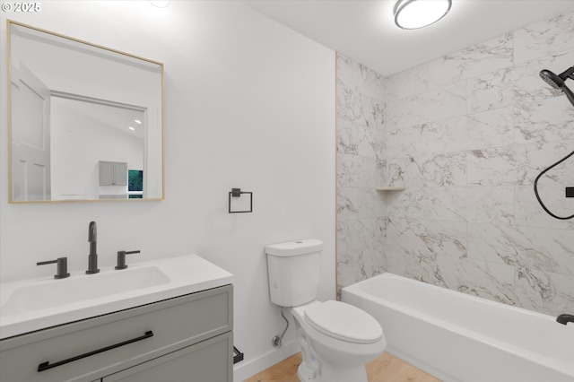 full bathroom featuring vanity, tiled shower / bath combo, wood-type flooring, and toilet