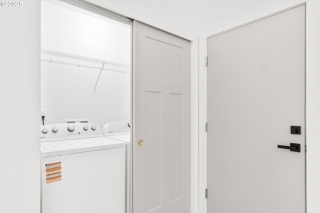 clothes washing area featuring separate washer and dryer