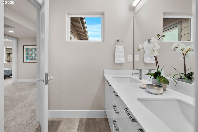 16537 SE Shimmering Leaf St, Happy Valley, OR 97086 - ensuite bathroom with double vanity, healthy amount of natural light, and wood finished floors
