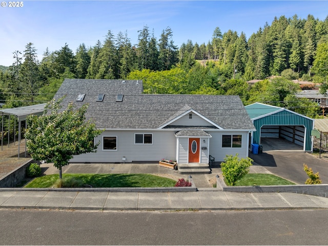 2111 Greenwood Ave, Reedsport, OR 97467 - view of front of property featuring a detached carport, a shingled roof, an outbuilding, and asphalt driveway