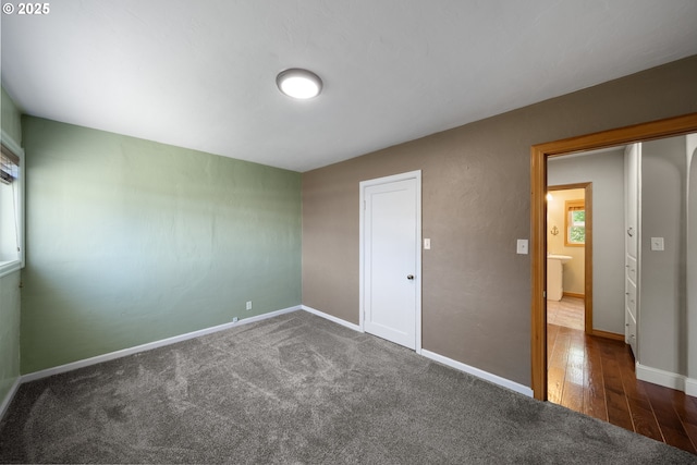 2111 Greenwood Ave, Reedsport, OR 97467 - unfurnished bedroom featuring baseboards, carpet floors, and wood finished floors