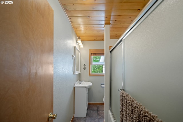 2111 Greenwood Ave, Reedsport, OR 97467 - bathroom featuring wood ceiling, toilet, an enclosed shower, vanity, and baseboards