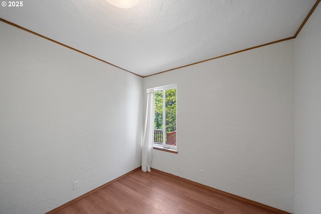 2111 Greenwood Ave, Reedsport, OR 97467 - unfurnished room featuring wood finished floors, ornamental molding, and a textured wall