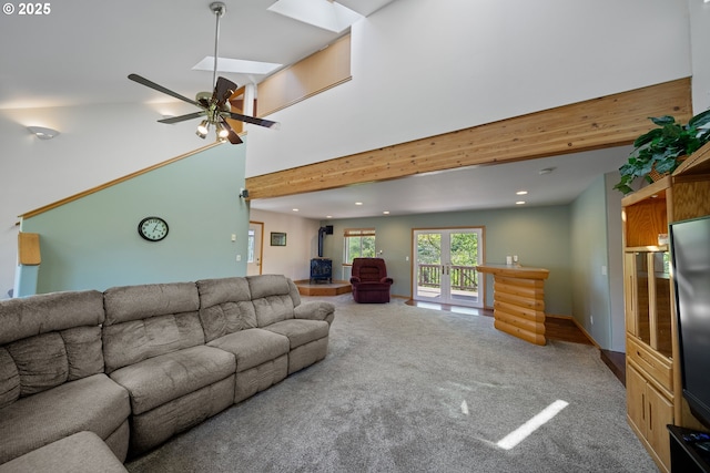 2111 Greenwood Ave, Reedsport, OR 97467 - carpeted living area with recessed lighting, a skylight, ceiling fan, and a high ceiling