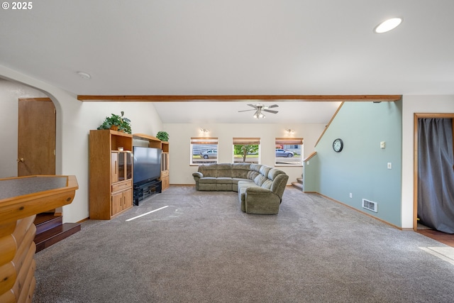 2111 Greenwood Ave, Reedsport, OR 97467 - living room featuring arched walkways, a ceiling fan, light colored carpet, and baseboards