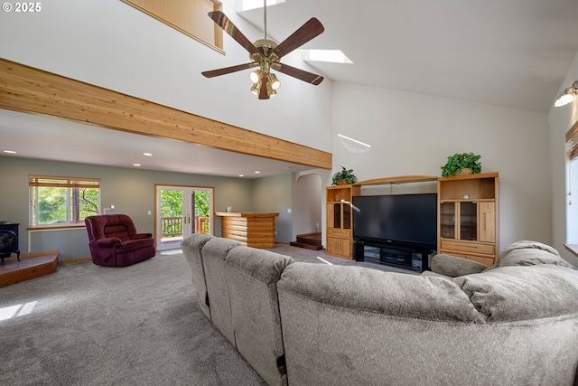 2111 Greenwood Ave, Reedsport, OR 97467 - carpeted living area with recessed lighting, a ceiling fan, a wood stove, high vaulted ceiling, and baseboards