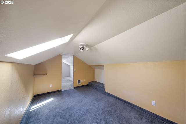 2111 Greenwood Ave, Reedsport, OR 97467 - additional living space featuring a skylight, lofted ceiling, carpet flooring, and baseboards