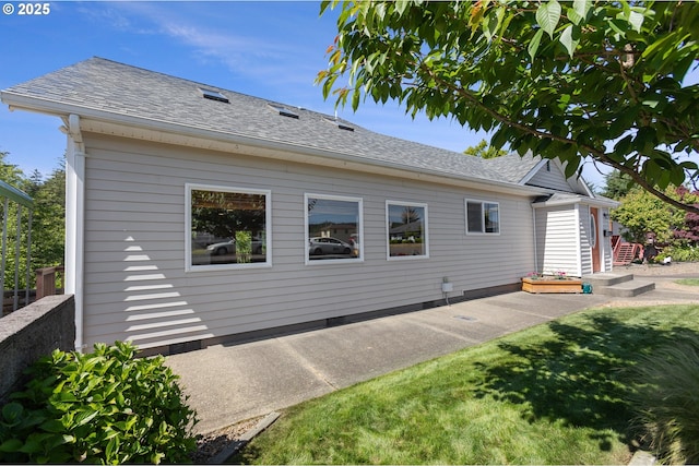 2111 Greenwood Ave, Reedsport, OR 97467 - view of home's exterior with a patio, a lawn, and roof with shingles