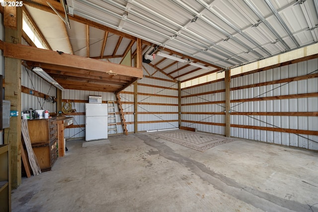 2111 Greenwood Ave, Reedsport, OR 97467 - garage with freestanding refrigerator and a garage door opener