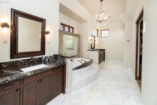 23021 Brushline Ct, Bend, OR 97701 - full bathroom with two vanities, a bath, a chandelier, and marble finish floors