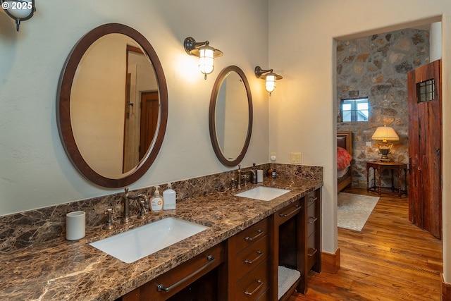 23021 Brushline Ct, Bend, OR 97701 - full bath with double vanity, wood finished floors, and connected bathroom