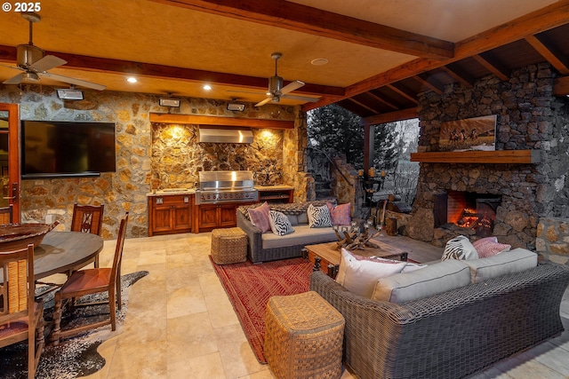 23021 Brushline Ct, Bend, OR 97701 - living room featuring a ceiling fan, beam ceiling, and an outdoor stone fireplace