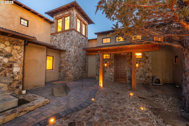 23021 Brushline Ct, Bend, OR 97701 - back of property featuring stone siding, stucco siding, and a patio area